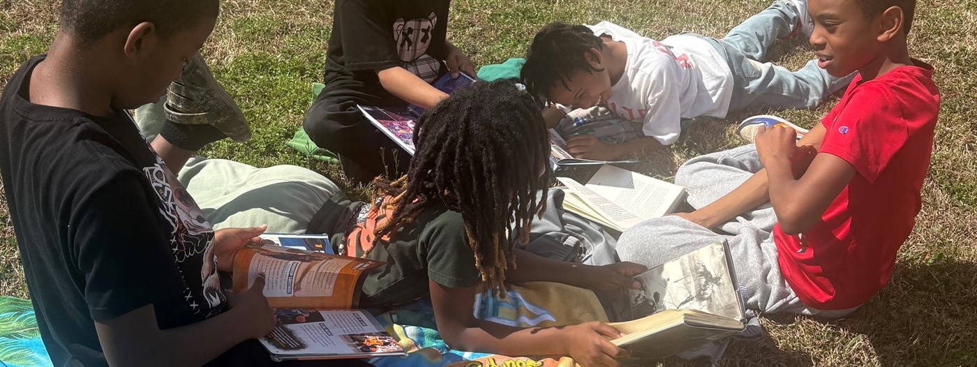 Students reading outside for Read Across America Week